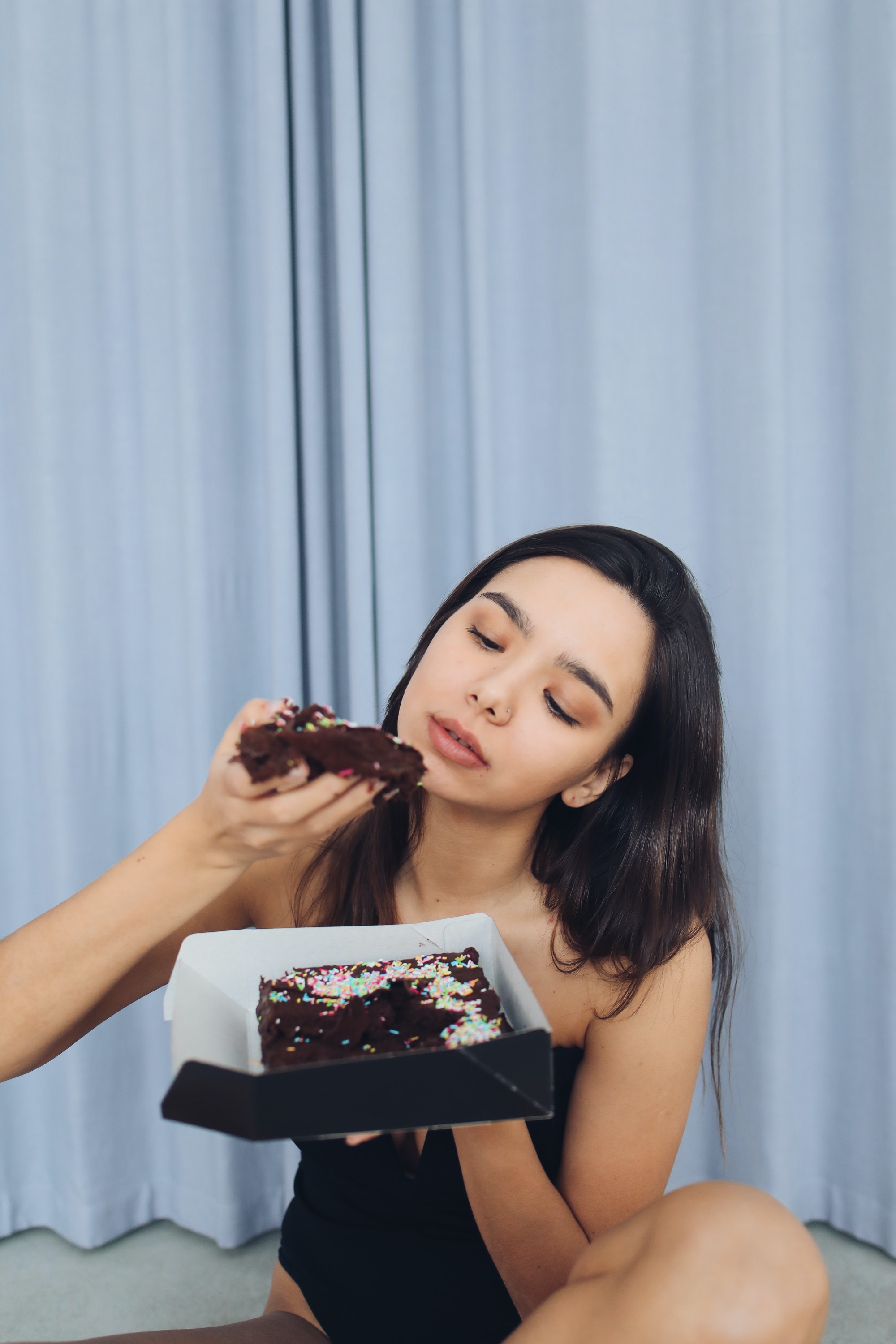 woman-eating-cake-eating-for-your-menstrual-cycle
