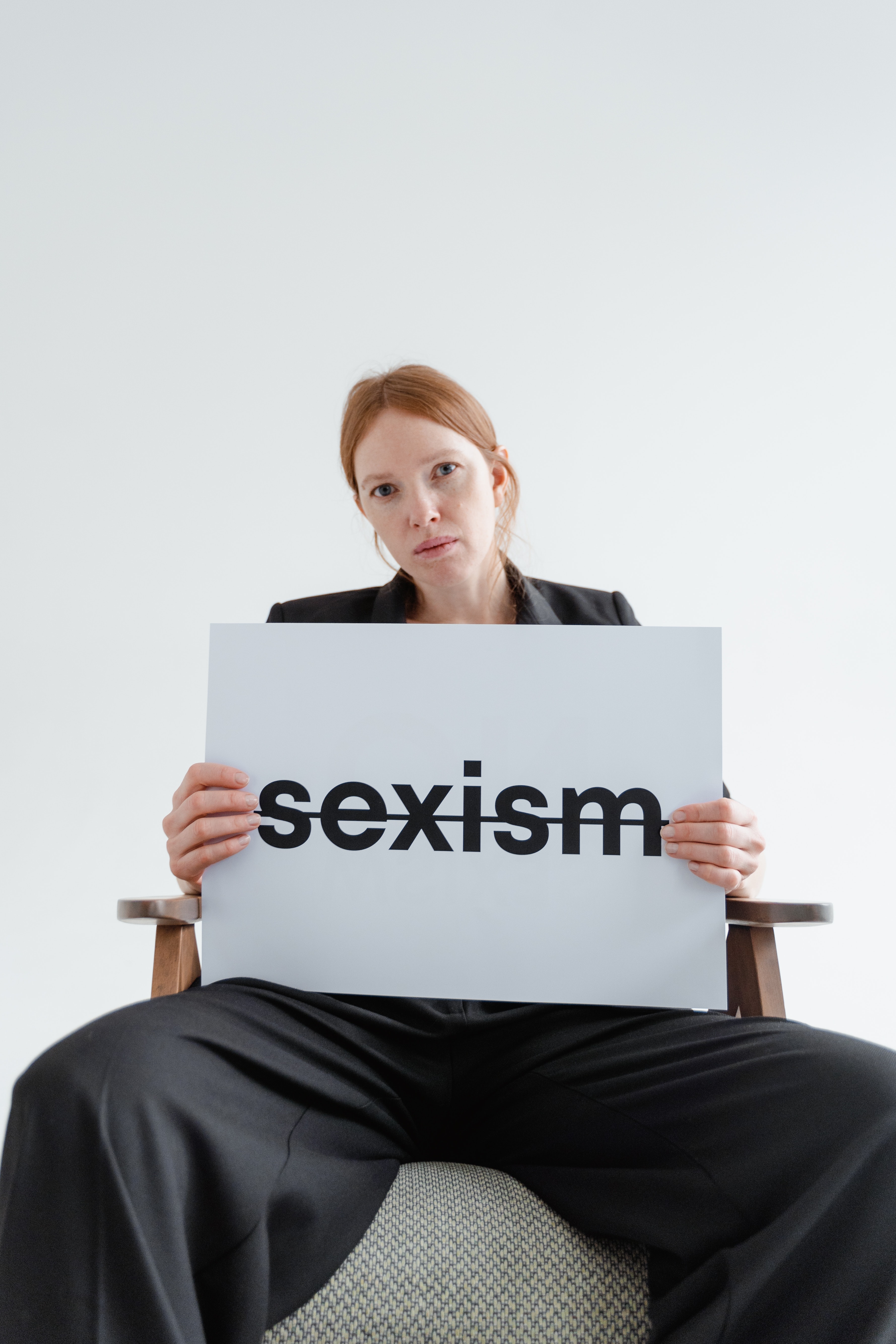 woman-holding-sign-sexism-the-everyday-sexism-project