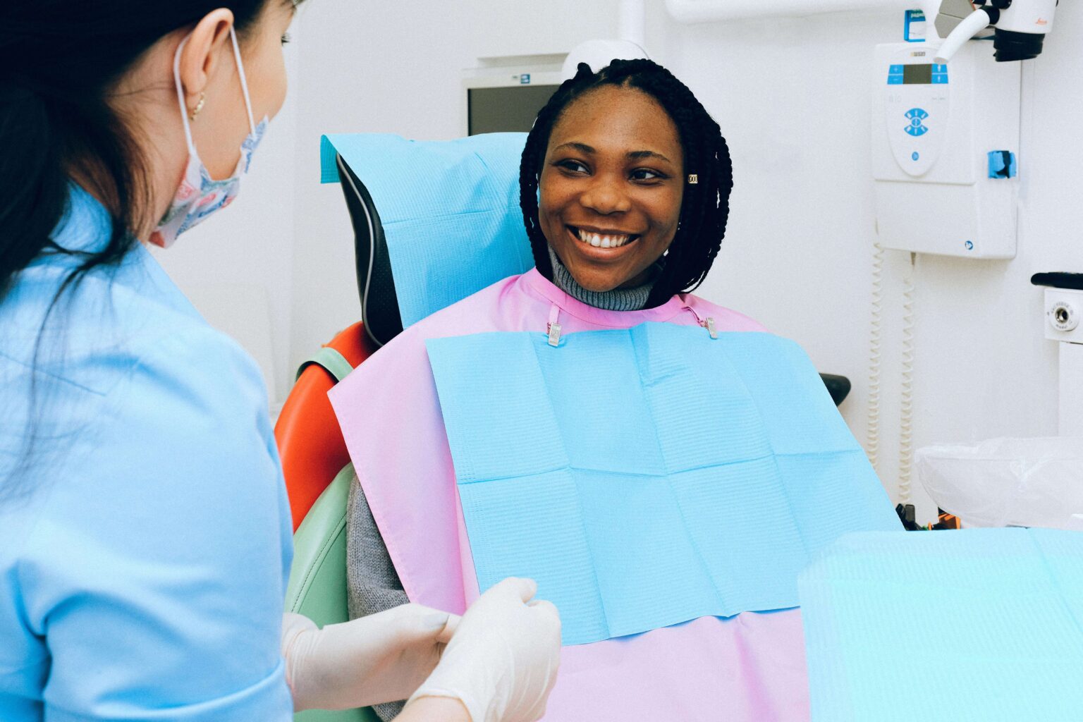 Black Woman at Dental Hygienist Examination - Women's Hormones and Dental Health