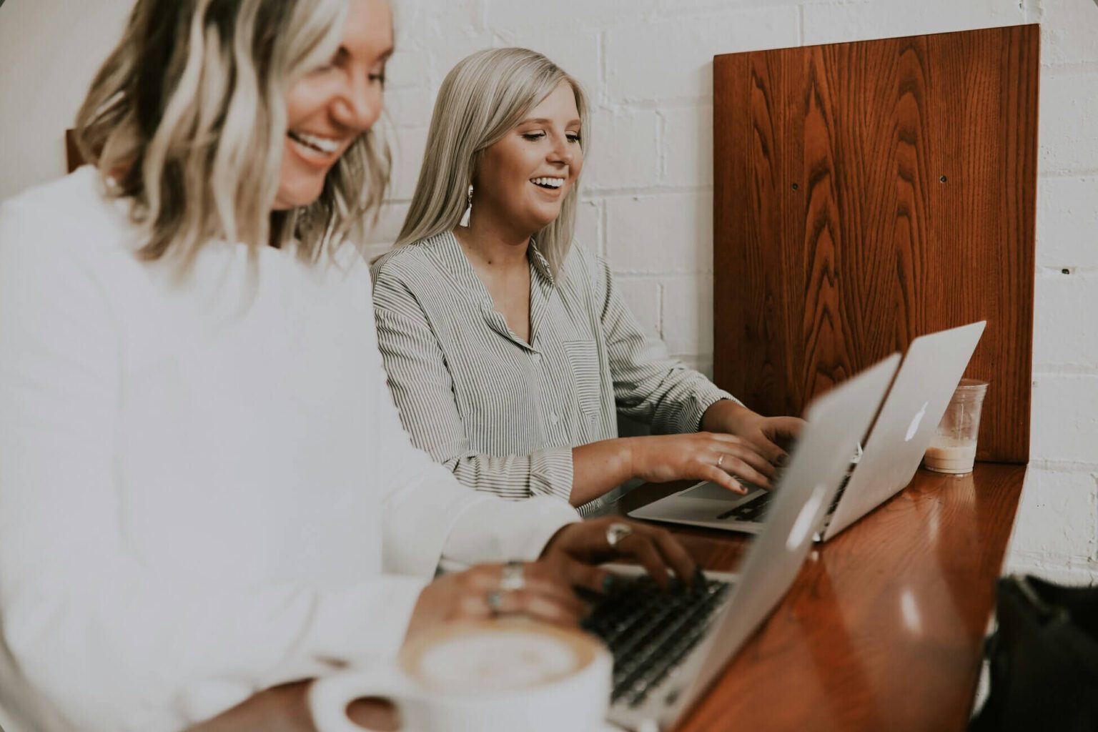 Two Blonde Women Working On Laptops Smiling - Best Online Business Tools 